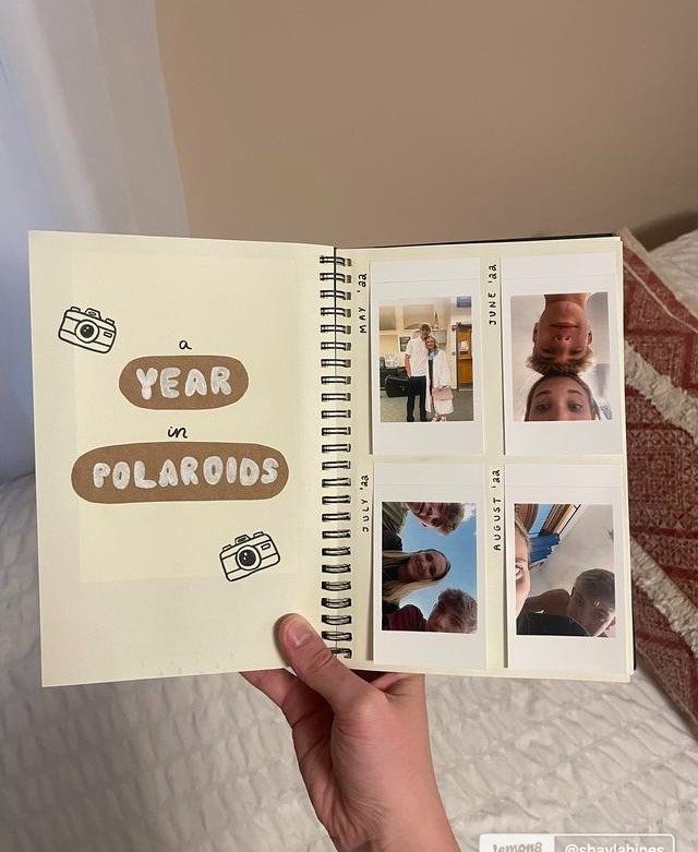 Spiral scrapbook showing a year in polaroids with photos of a couple.
