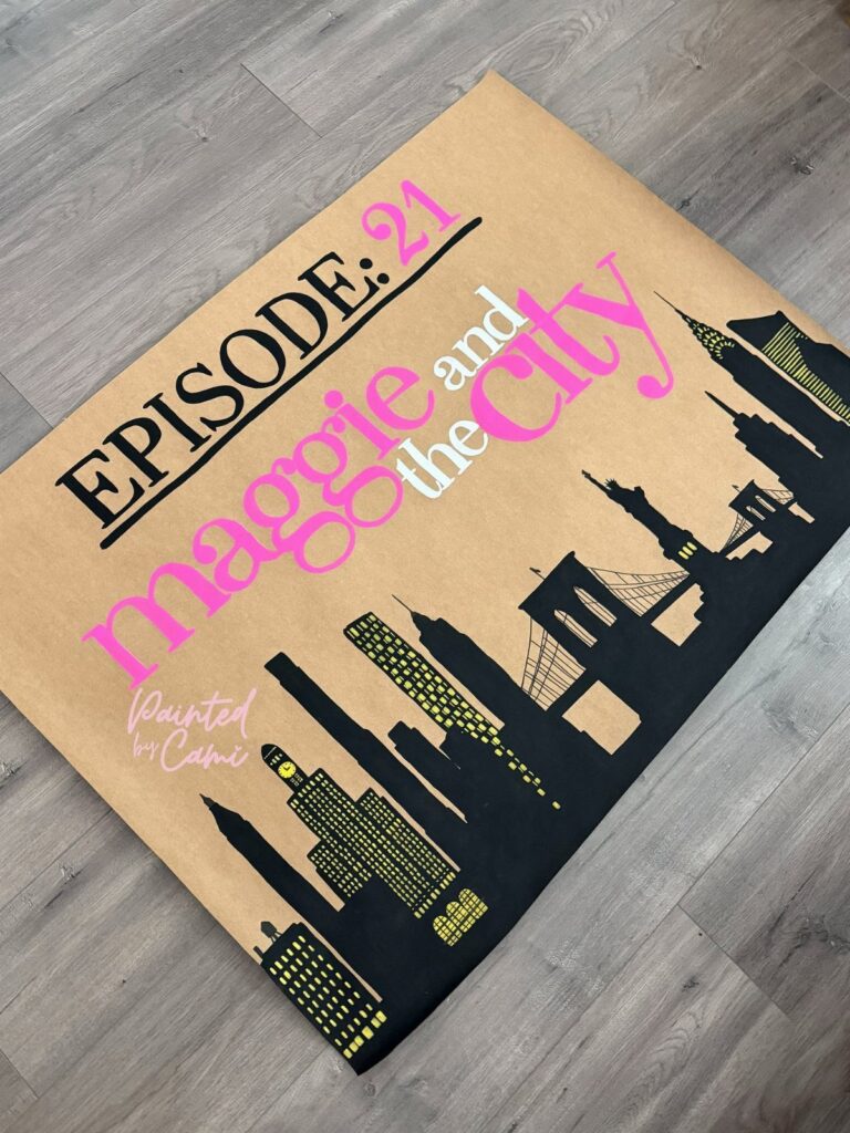 Hand-painted birthday banner with city skyline and text Episode 21 Maggie and the City