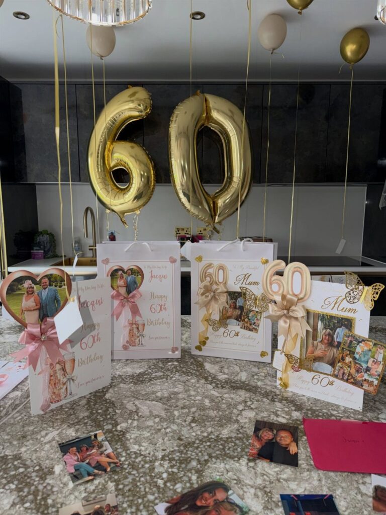 Gold 60 balloons and personalized birthday cards for a mother's 60th birthday celebration.
