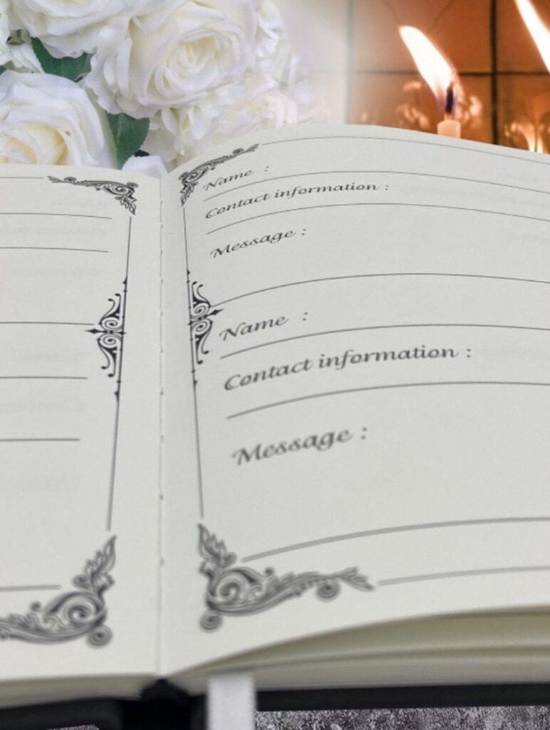Open guest book with name and message fields next to white roses and candle