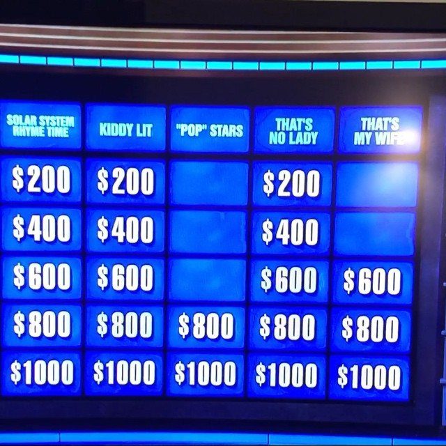 Digital game board with blue categories and dollar amounts for a trivia game.
